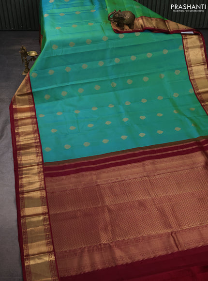 Pure kanchipuram silk saree teal green and dark magenta pink with zari woven buttas and zari woven korvai border