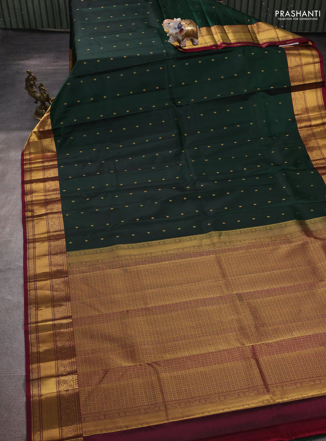Pure kanchipuram silk saree bottle green and dark magenta pink with allover zari woven buttas and zari woven border