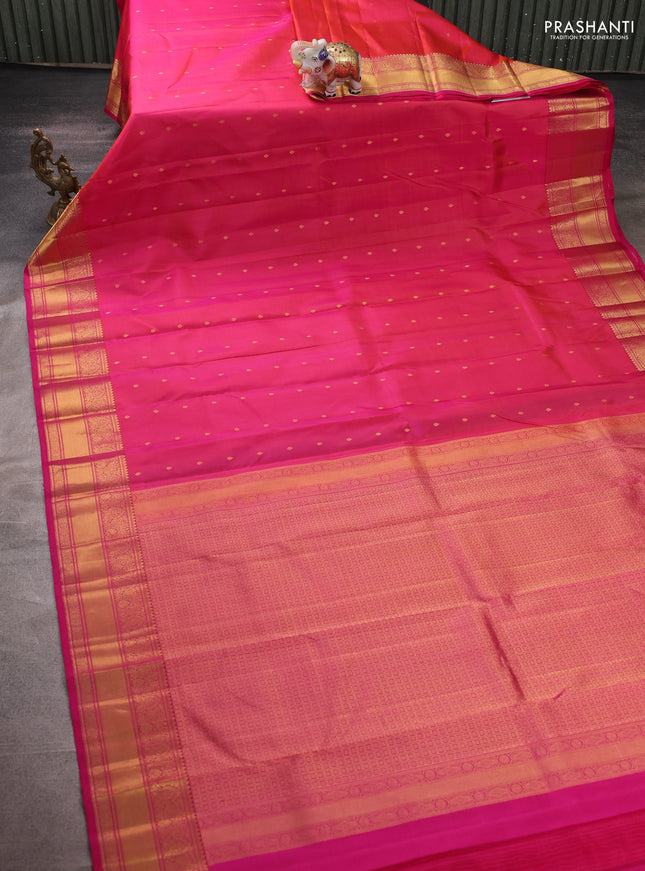 Pure kanchipuram silk saree dual shade of pinkish orange with allover zari woven buttas and zari woven border