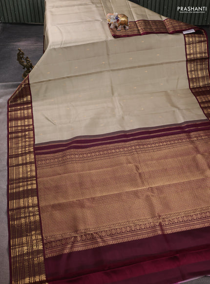 Pure kanchipuram silk saree beige and wine shade with zari woven buttas and zari woven korvai border