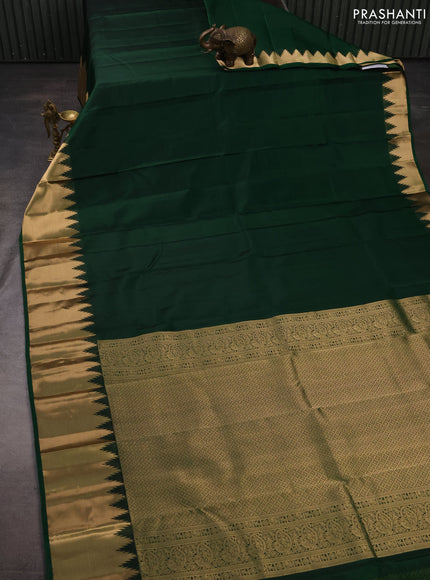 Pure kanchipuram silk saree dark green with plain body and temple design zari woven border