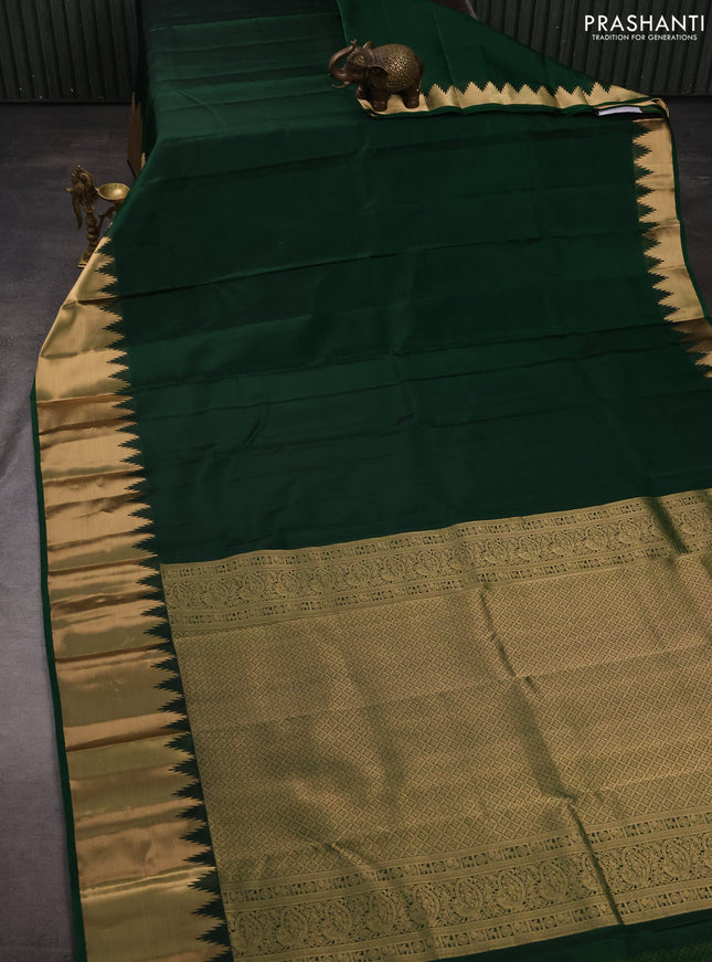 Pure kanchipuram silk saree dark green with plain body and temple design zari woven border