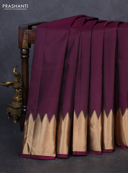 Pure kanchipuram silk saree wine shade with plain body and temple design zari woven border