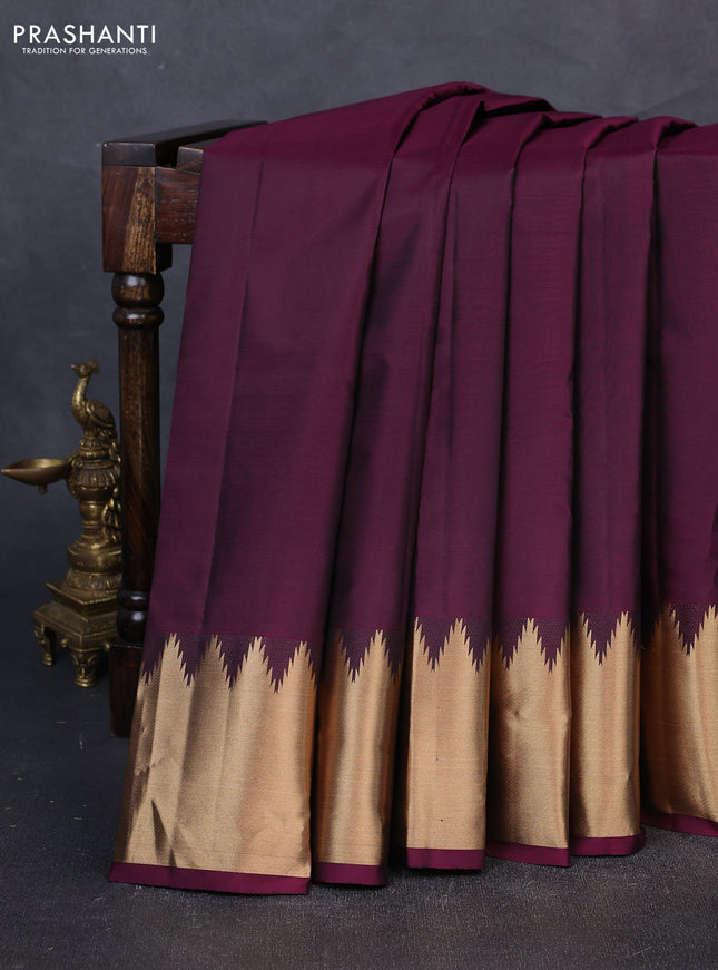 Pure kanchipuram silk saree wine shade with plain body and temple design zari woven border