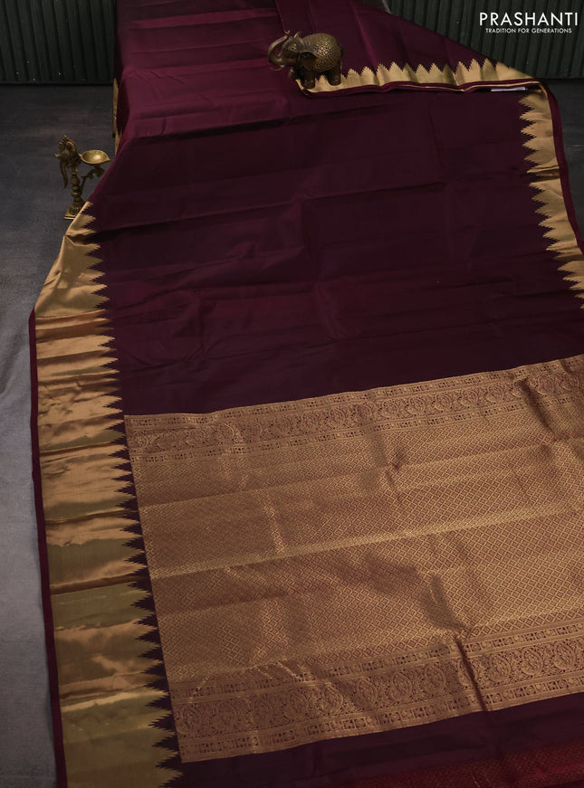 Pure kanchipuram silk saree wine shade with plain body and temple design zari woven border