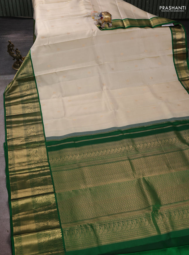 Pure kanchipuram silk saree cream and green with zari woven buttas and long rich zari woven korvai border