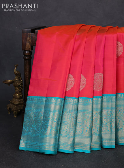 Pure kanchipuram silk saree dual shade of pinkish orange and teal blue with zari woven buttas and long rich zari woven korvai border