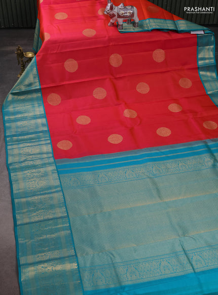 Pure kanchipuram silk saree dual shade of pinkish orange and teal blue with zari woven buttas and long rich zari woven korvai border
