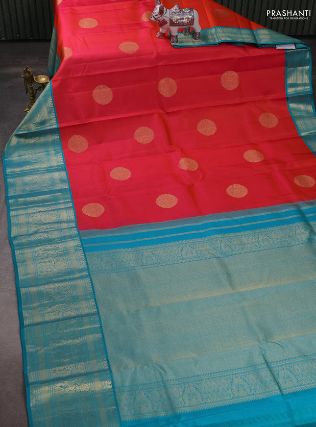 Pure kanchipuram silk saree dual shade of pinkish orange and teal blue with zari woven buttas and long rich zari woven korvai border