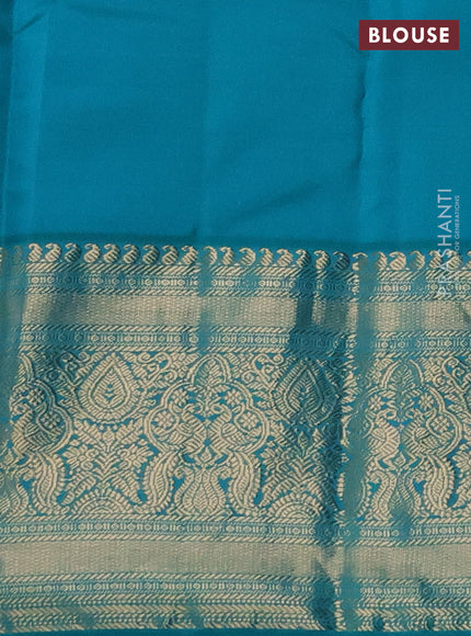 Pure kanchipuram silk saree dual shade of pinkish orange and teal blue with zari woven buttas and long rich zari woven korvai border