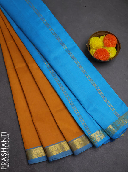 Silk cotton saree mustard yellow and light blue with plain body and zari woven border