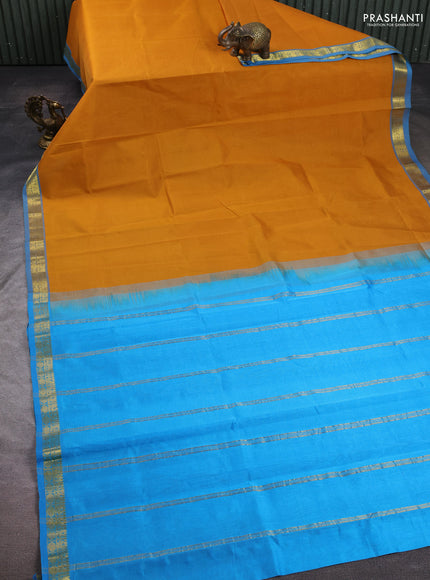 Silk cotton saree mustard yellow and light blue with plain body and zari woven border