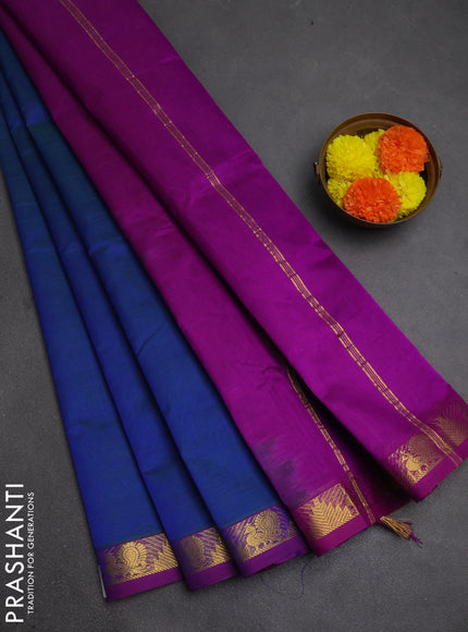 Silk cotton saree dual shade of bluish green and purple with plain body and zari woven border