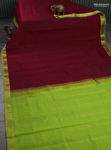 Silk cotton saree maroon and light green with plain body and zari woven border