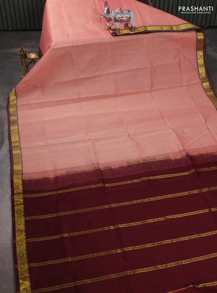 Silk cotton saree peach shade and deep maroon with plain body and zari woven border
