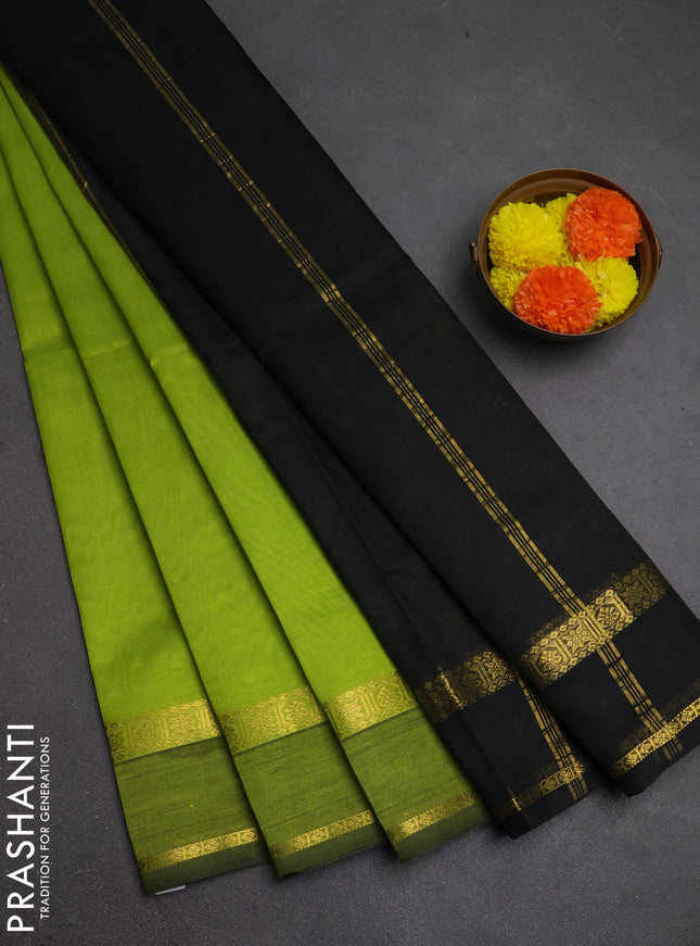 Silk cotton saree light green and black with plain body and rettapet zari woven border