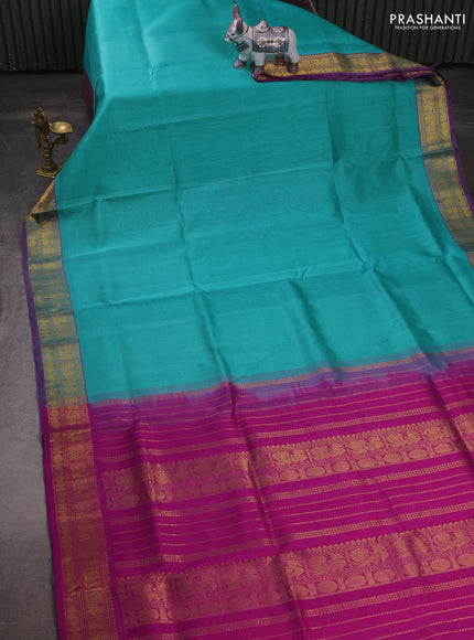 Silk cotton saree teal blue and purple with plain body and zari woven border