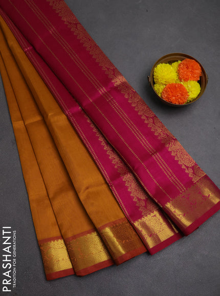 Silk cotton saree dark mustard and magenta pink with plain body and zari woven border