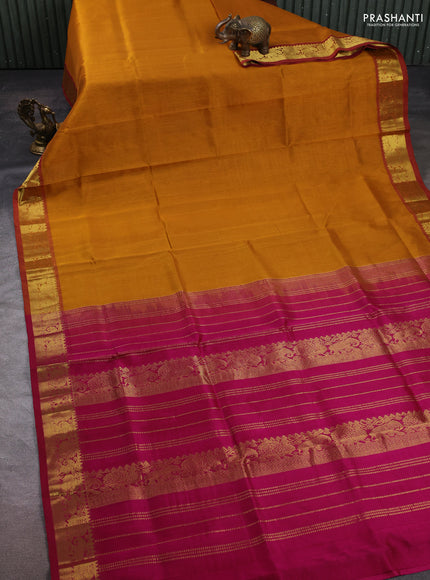 Silk cotton saree dark mustard and magenta pink with plain body and zari woven border
