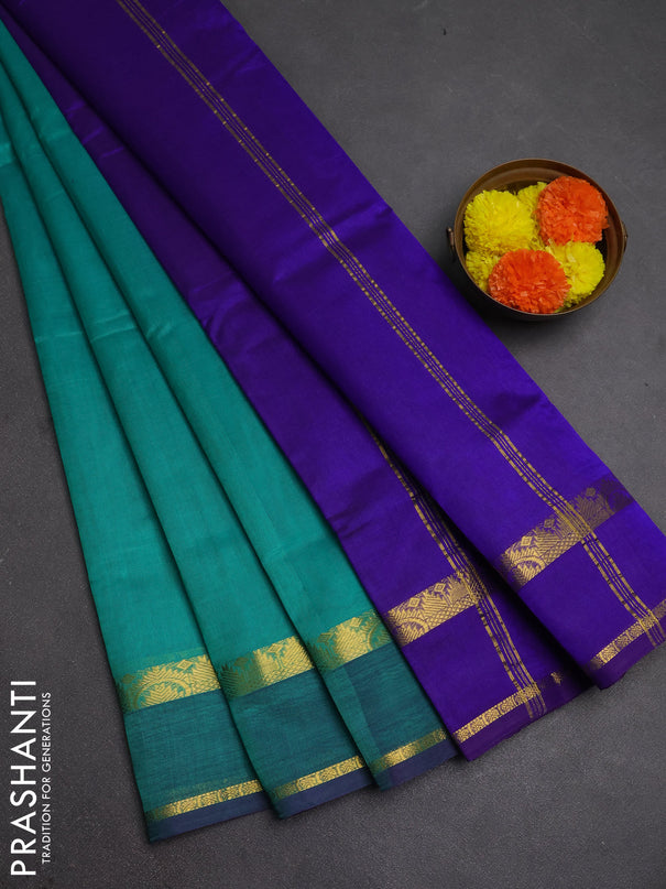 Silk cotton saree teal green and violet with plain body and rettapet zari woven border