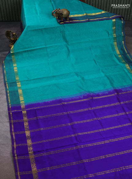 Silk cotton saree teal green and violet with plain body and rettapet zari woven border
