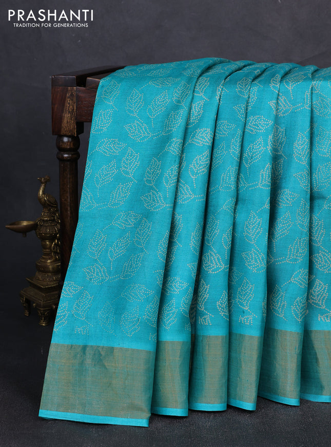 Pure tussar silk saree teal blue with allover leaf prints and zari woven border