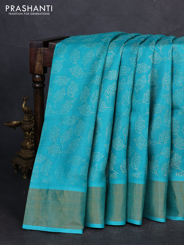 Pure tussar silk saree teal blue with allover leaf prints and zari woven border