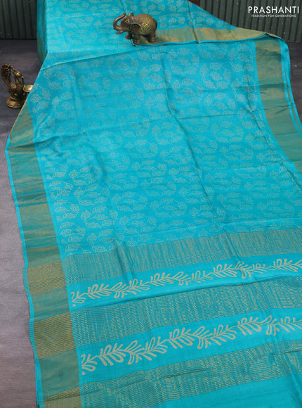Pure tussar silk saree teal blue with allover leaf prints and zari woven border
