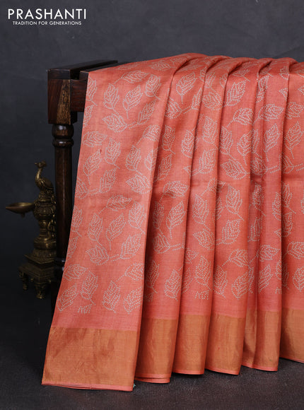 Pure tussar silk saree peach orange with allover leaf prints and zari woven border
