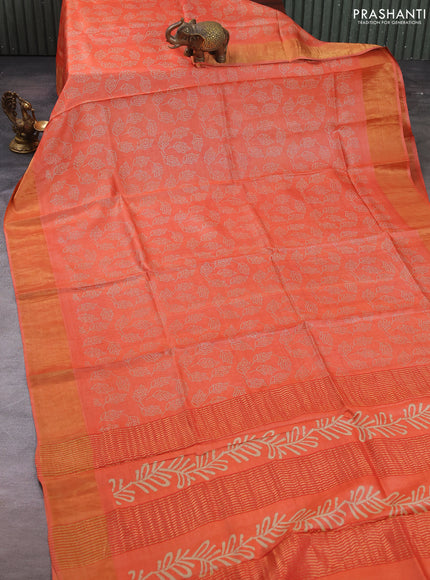 Pure tussar silk saree peach orange with allover leaf prints and zari woven border