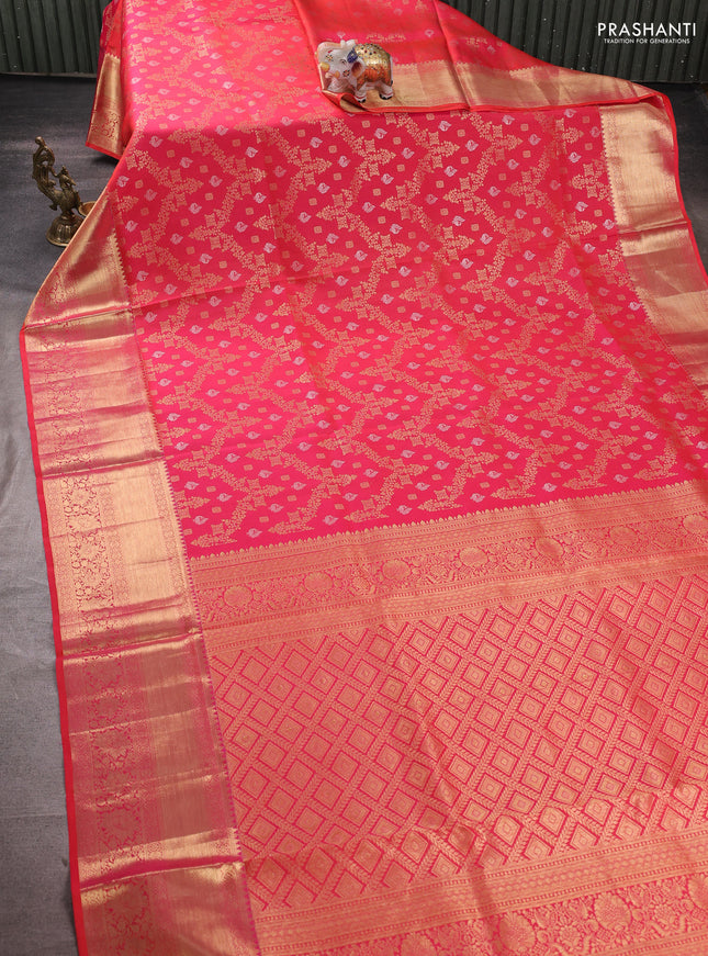 Pure kanchipuram silk saree dual shade of pinkish orange with allover zari woven brocade weaves and rich zari woven border