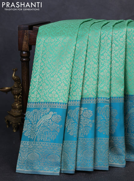 Pure kanchipuram silk saree teal green and cs blue with allover zari woven brocade weaves and long rich zari woven border