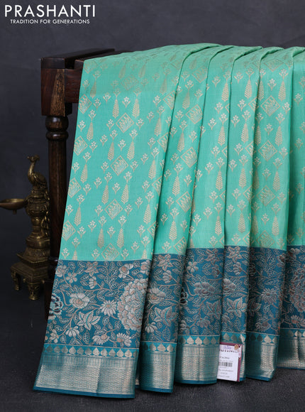 Pure kanchipuram silk saree teal green shade and peacock green with allover zari woven brocade weaves and rich floral zari woven border