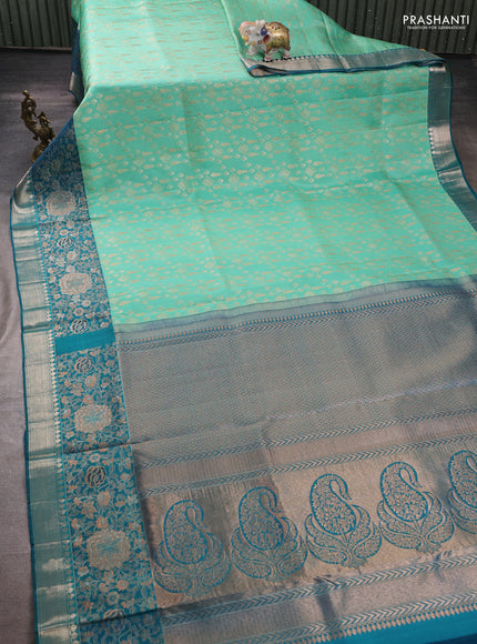 Pure kanchipuram silk saree teal green shade and peacock green with allover zari woven brocade weaves and rich floral zari woven border