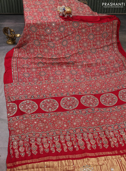Modal silk saree tomato red with allover ajrakh prints and mirror & sequin embroidery pallu