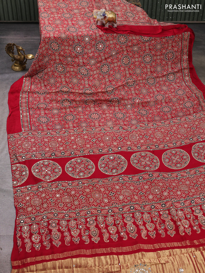 Modal silk saree tomato red with allover ajrakh prints and mirror & sequin embroidery pallu
