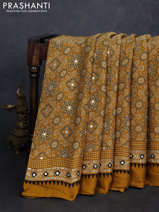 Modal silk saree dark mustard with allover ajrakh prints and mirror & sequin embroidery pallu