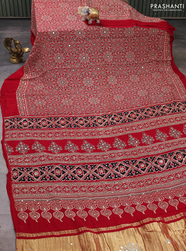 Modal silk saree tomato red with allover ajrakh prints and mirror & sequin embroidery pallu