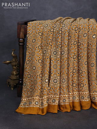 Modal silk saree dark mustard with allover ajrakh prints and mirror & sequin embroidery pallu
