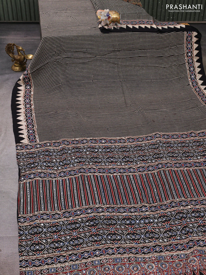Modal silk saree black with allover stripe prints and ajrakh prints mirror & sequin embroidery pallu
