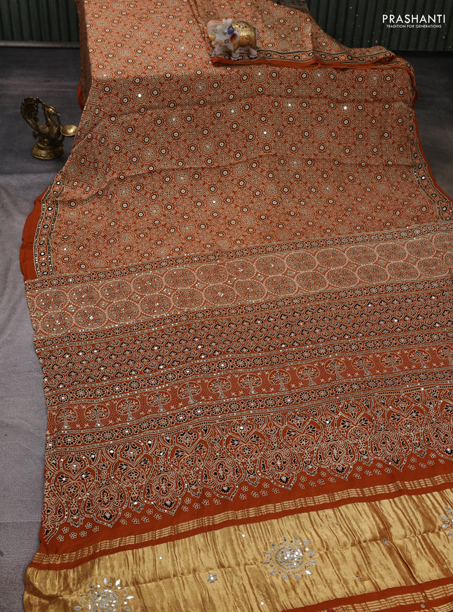 Modal silk saree dark mustard with allover ajrakh prints and mirror & sequin embroidery pallu