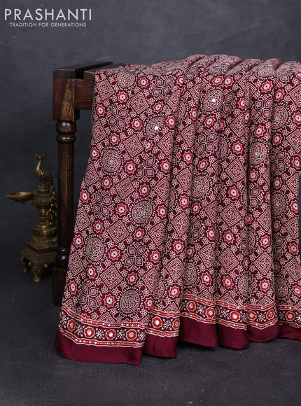 Modal silk saree wine shade with allover ajrakh prints and mirror & sequin embroidery pallu
