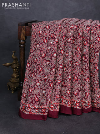 Modal silk saree wine shade with allover ajrakh prints and mirror & sequin embroidery pallu