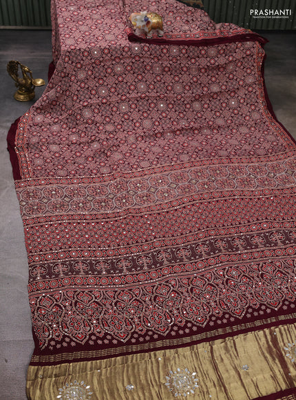 Modal silk saree wine shade with allover ajrakh prints and mirror & sequin embroidery pallu