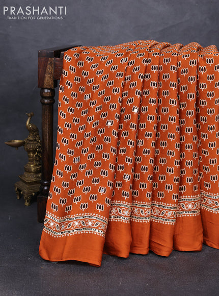 Modal silk saree dark mustard with allover ajrakh prints and mirror & sequin embroidery pallu