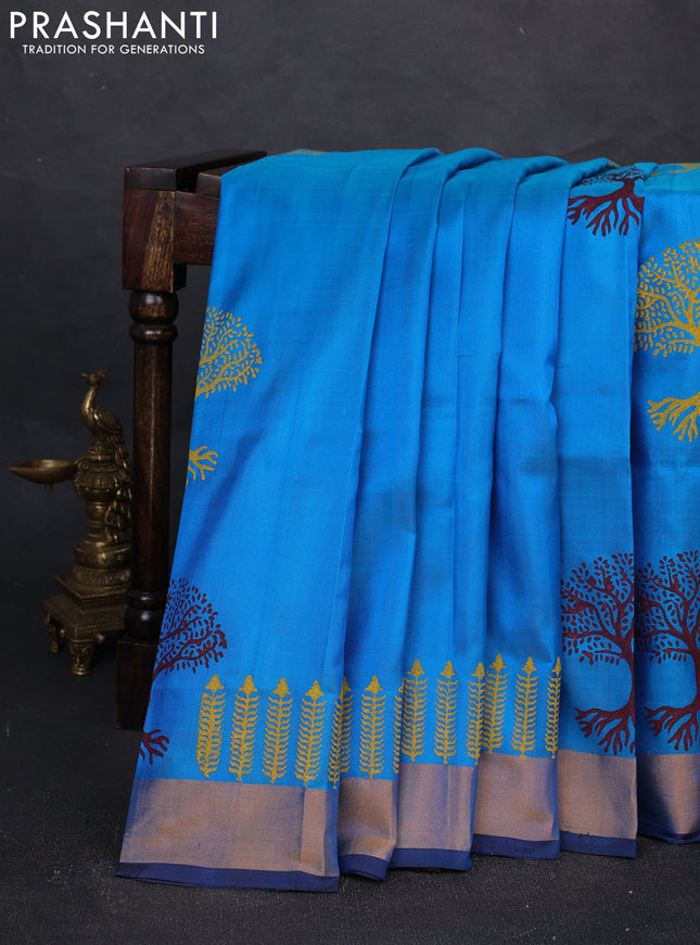 Uppada block printed silk saree cs blue and coffee brown with tree butta prints and zari woven border