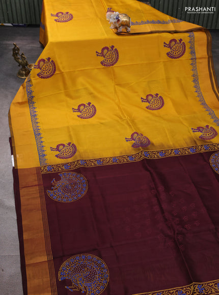 Uppada block printed silk saree mustard yellow and coffee brown with peacock butta prints and zari woven border