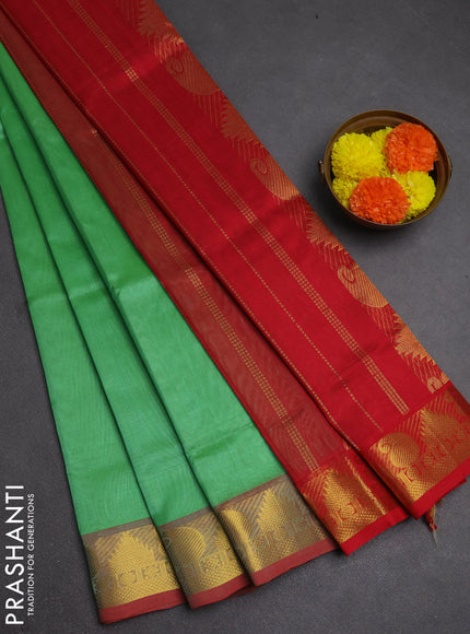 Silk cotton saree green and red with plain body and paisley & temple zari woven border