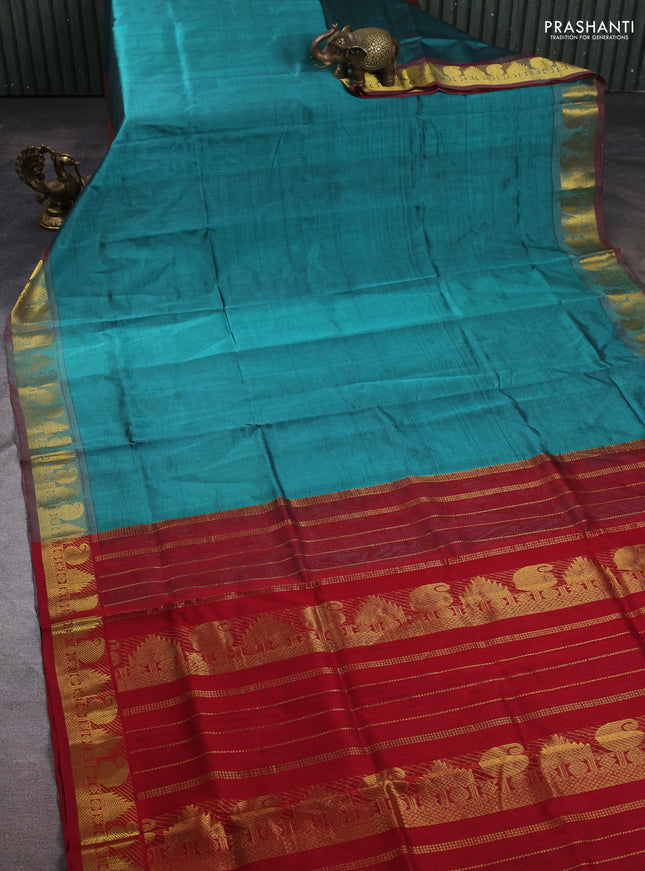 Silk cotton saree teal green shade and maroon with plain body and paisley & temple zari woven border