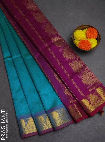 Silk cotton saree dual shade of teal blue and purple with plain body and paisley & temple zari woven border